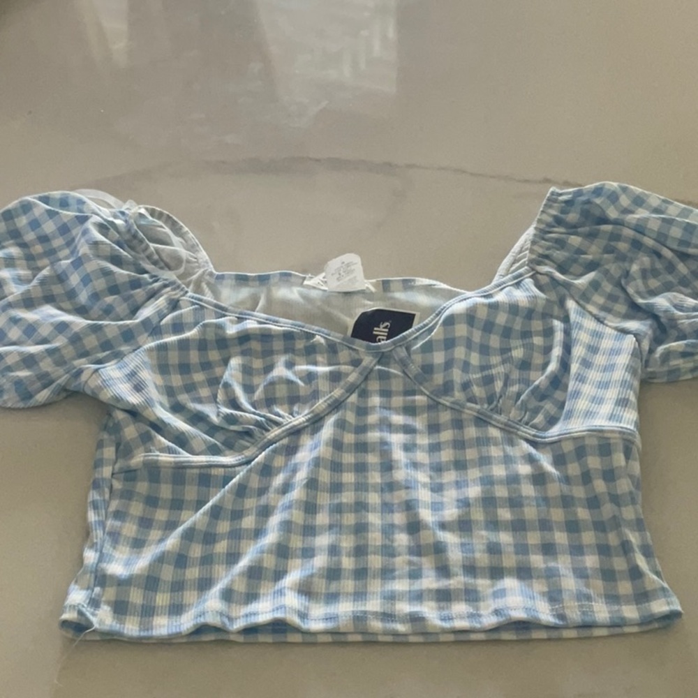 NWOT blue blouse made of stretchable fabric.